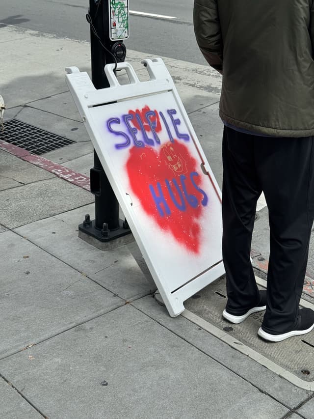 sign that says "selfie hugs"
